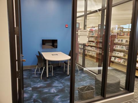 Photo of Study Room B, showing a glass-enclosed room with a table, 4 chairs, and wall-mounted television.