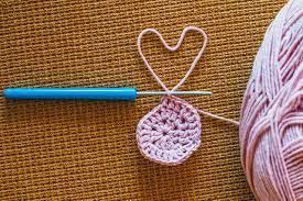 image of crochet hook, ball of yarn, and crocheted circle