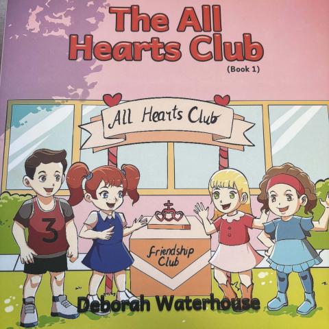 book cover with the title "the all hearts club" four children stand around a podium that reads "friendship club" 