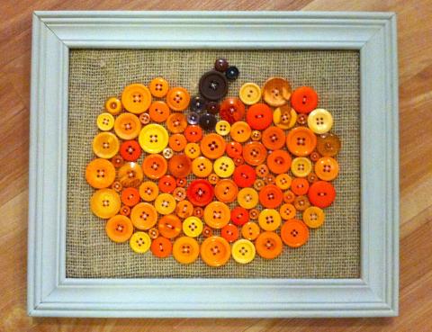 image of pumpkin craft made of orange buttons in a frame