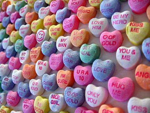 a wall of conversation hearts with different sayings on them