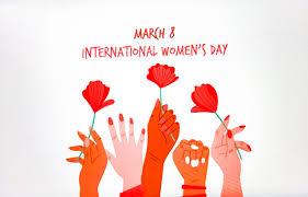 women's hands holding poppies and the words "march 8 international women's day" in red 