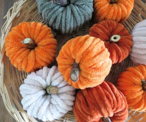 photo of orange, white, and green pumpkins made from yarn