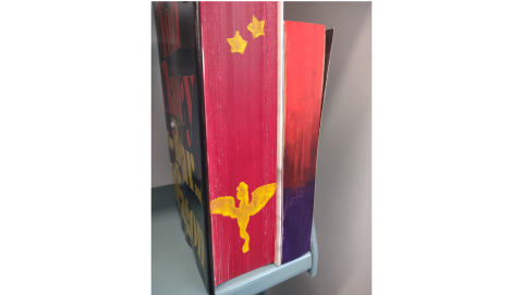 View of the text block of two books that have been painted.