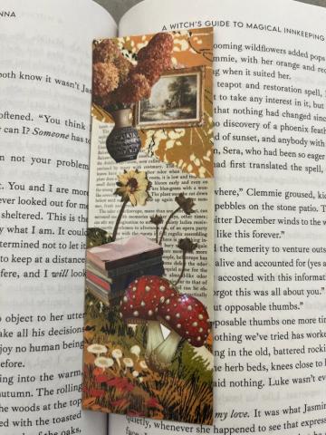 Image of a bookmark featuring a collage of images from magazines as it lays across the open pages of a book.