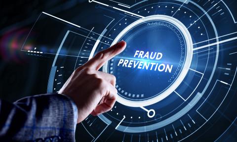 Futuristic depiction of a hand selecting a button labeled Fraud Prevention on a holographic display.