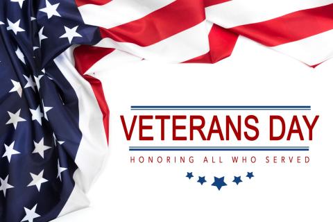 America Flag next to the words "veterans day honoring those who served" 