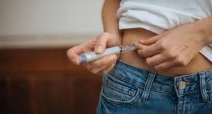 photograph of a person wrapping a tape measure around their waist