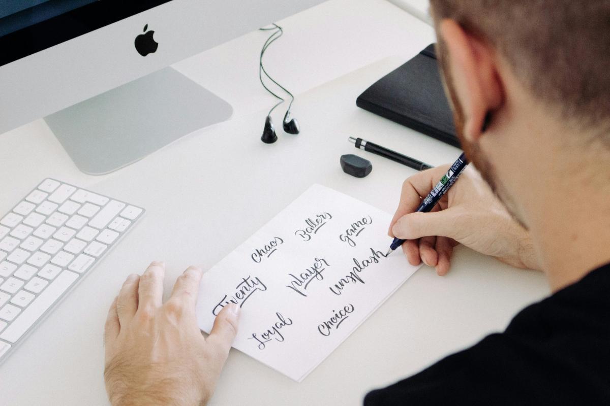 man writing calligraphy