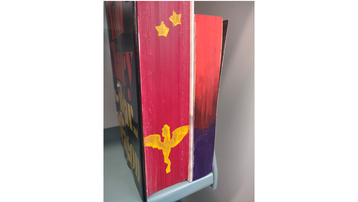 View of the text block of two books that have been painted.